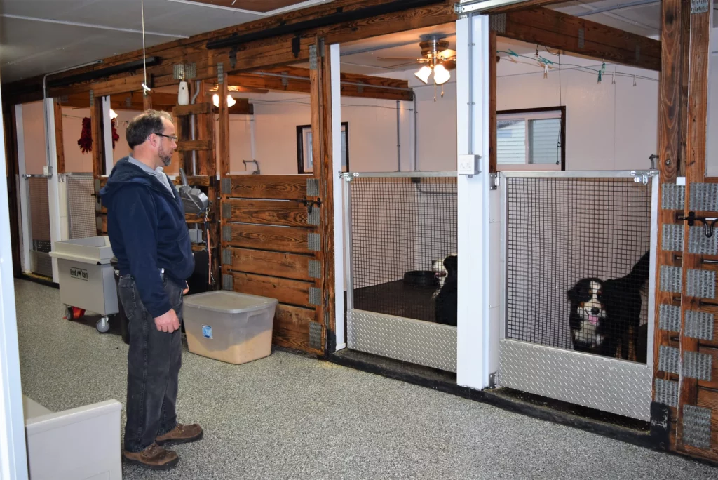 Man and his two black Tric-color dog